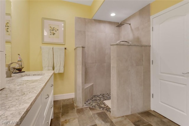 bathroom with vanity and tiled shower