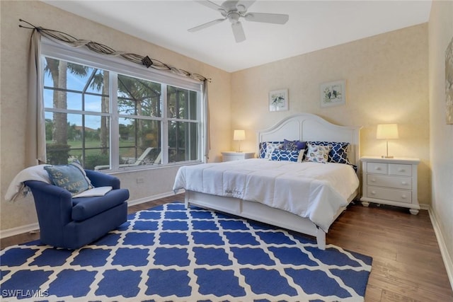 bedroom with ceiling fan and dark wood-type flooring