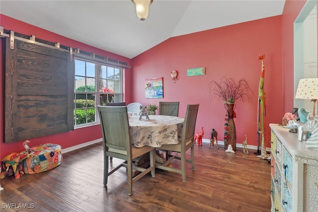 dining room with dark wood-type flooring and lofted ceiling