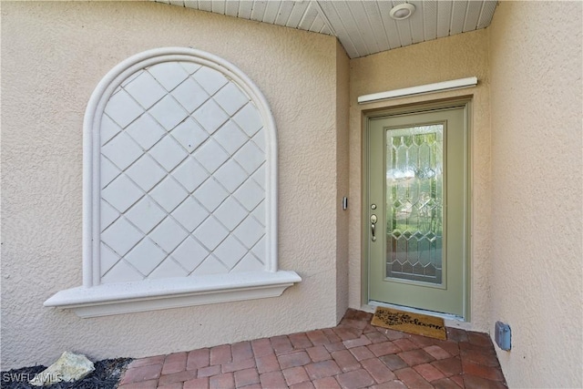 property entrance with stucco siding