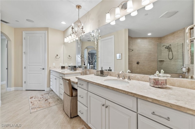 2550 Marquesa Royale Ln Unit 8-101, Naples, FL 34109 - bathroom featuring a walk in shower, vanity, a chandelier, baseboards, and visible vents
