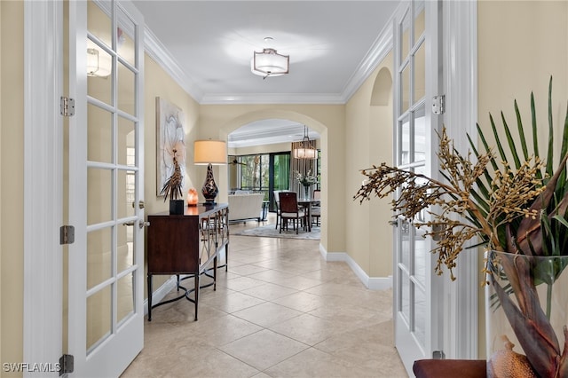 corridor with french doors, ornamental molding, and light tile patterned flooring