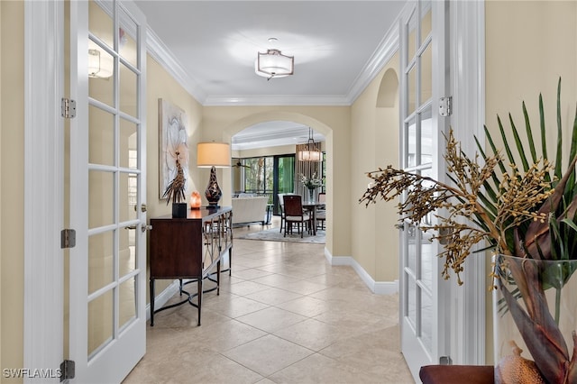 2550 Marquesa Royale Ln Unit 8-101, Naples, FL 34109 - hallway featuring crown molding, arched walkways, baseboards, and an inviting chandelier