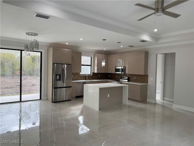 kitchen with gray cabinetry, a center island, stainless steel appliances, crown molding, and pendant lighting