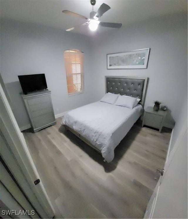 bedroom featuring ceiling fan and light hardwood / wood-style flooring