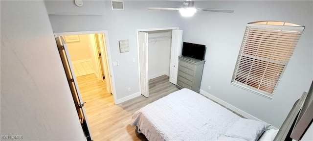 bedroom with light wood-type flooring, a closet, and ceiling fan