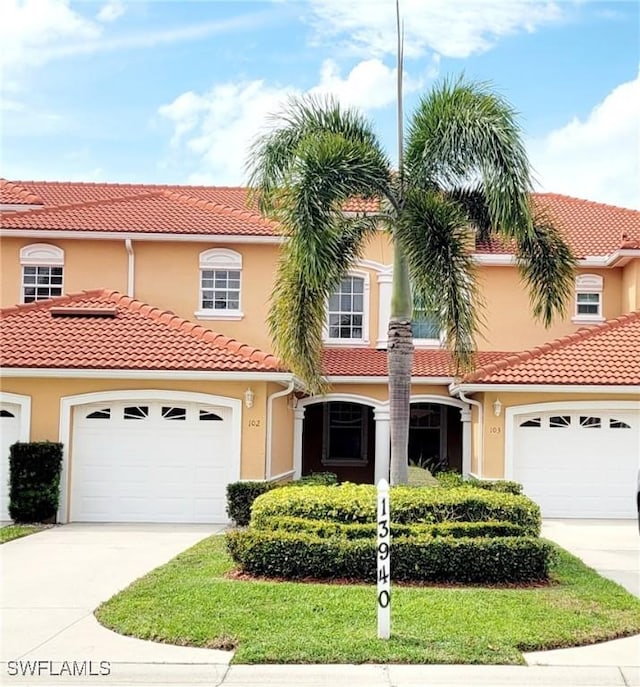 mediterranean / spanish-style house with a garage