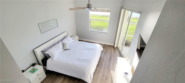 bedroom featuring hardwood / wood-style floors and ceiling fan