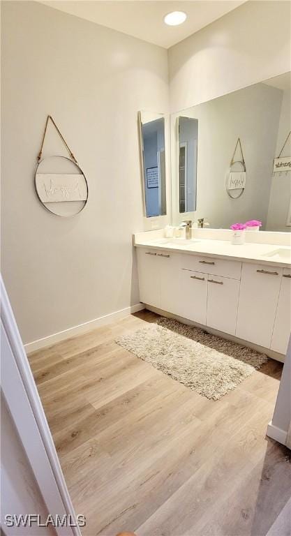 bathroom with hardwood / wood-style floors and vanity