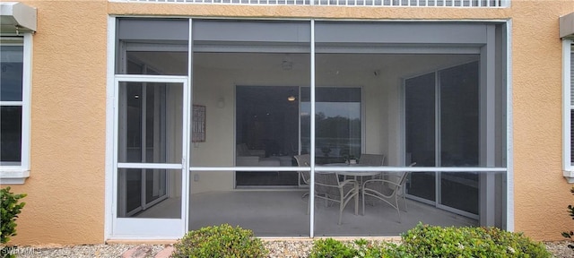 back of property with a sunroom and a patio area