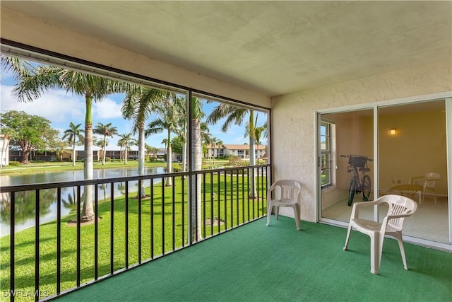 unfurnished sunroom with a water view