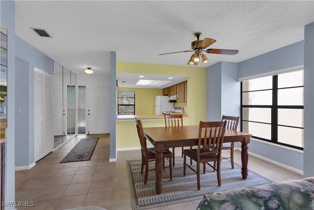 dining area featuring light tile patterned floors and ceiling fan