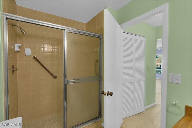 bathroom with a shower with shower door