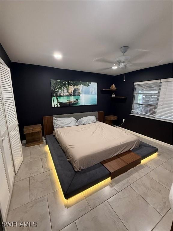 bedroom with ceiling fan and a closet