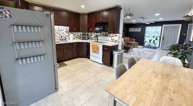 kitchen with white range with electric cooktop, ceiling fan, refrigerator, dark brown cabinets, and tasteful backsplash