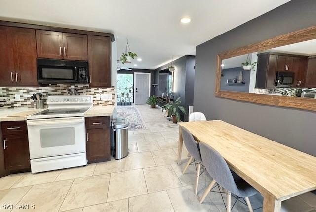 kitchen featuring light tile patterned flooring, dark brown cabinetry, white electric range, and decorative backsplash