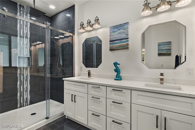 bathroom with tile patterned flooring, vanity, and a shower with door