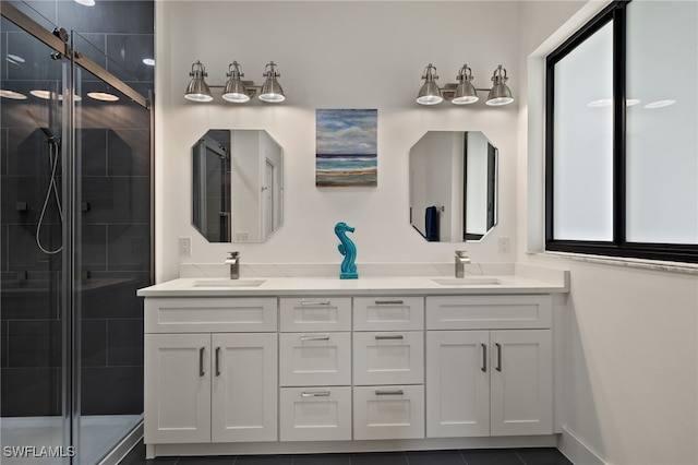 bathroom with tile patterned floors, vanity, and a shower with shower door