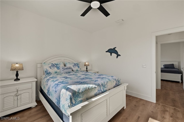 bedroom with ceiling fan and dark hardwood / wood-style floors