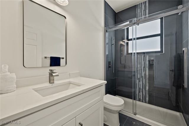 bathroom featuring walk in shower, tile patterned flooring, vanity, and toilet