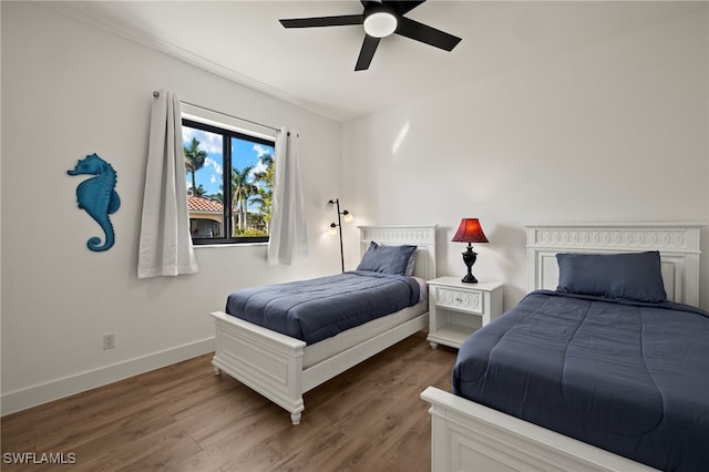 bedroom featuring hardwood / wood-style flooring and ceiling fan