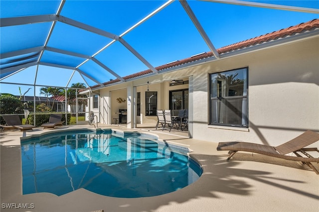 view of pool with a lanai, area for grilling, ceiling fan, and a patio area