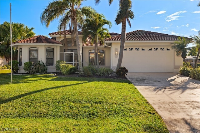 mediterranean / spanish-style home with a garage and a front yard