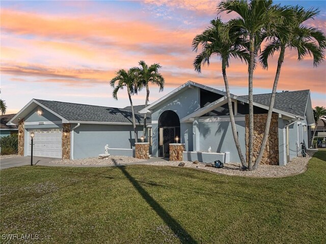 single story home with a yard and a garage