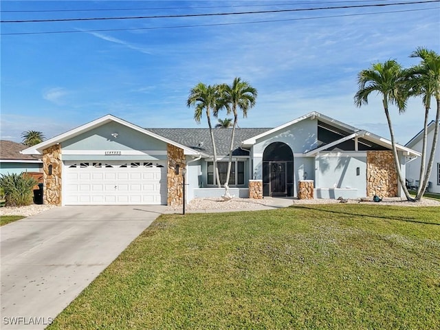 view of front of house featuring a front yard and a garage