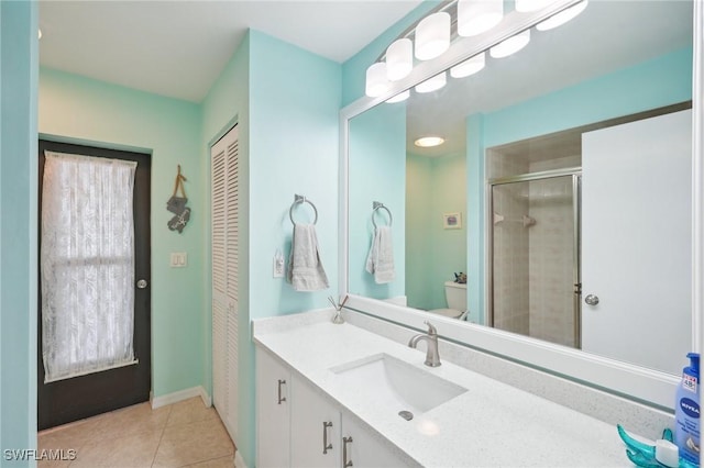 bathroom with tile patterned flooring, vanity, toilet, and a shower with door