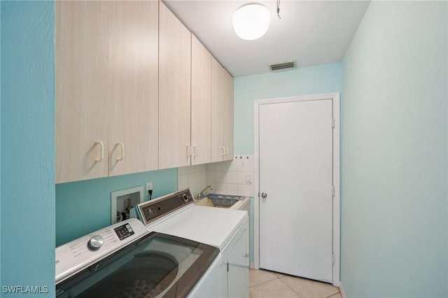 4925 SW 11th Ave, Cape Coral, FL 33914 - laundry area with cabinet space, independent washer and dryer, and light tile patterned flooring