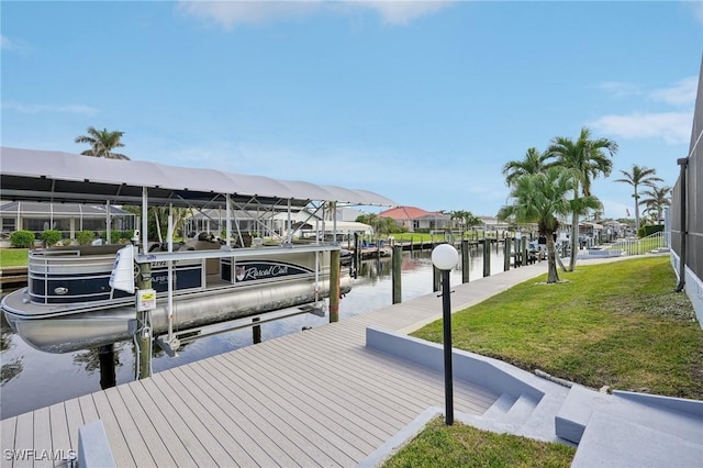 view of dock featuring a yard, a water view, and glass enclosure