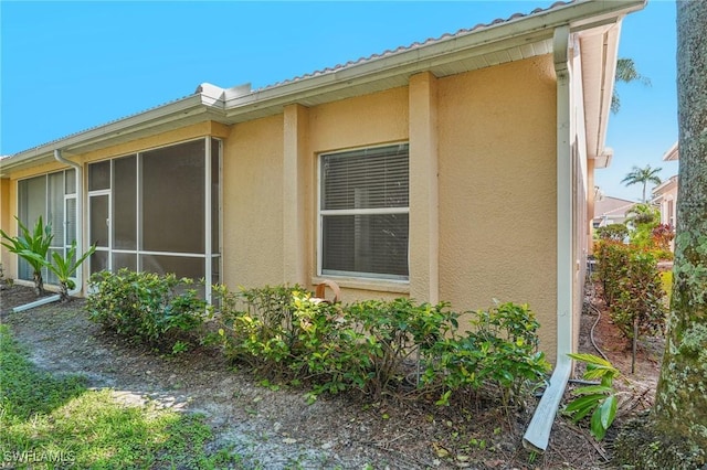 view of home's exterior with a sunroom