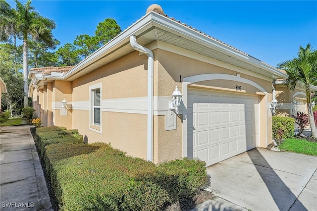 view of side of home featuring a garage