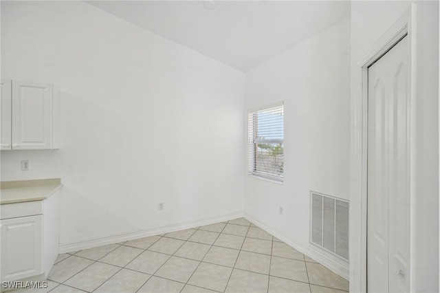 empty room with light tile patterned floors