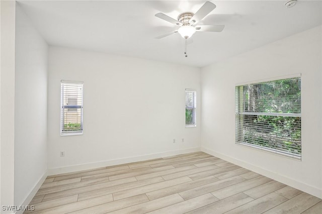 empty room with light wood-type flooring and ceiling fan