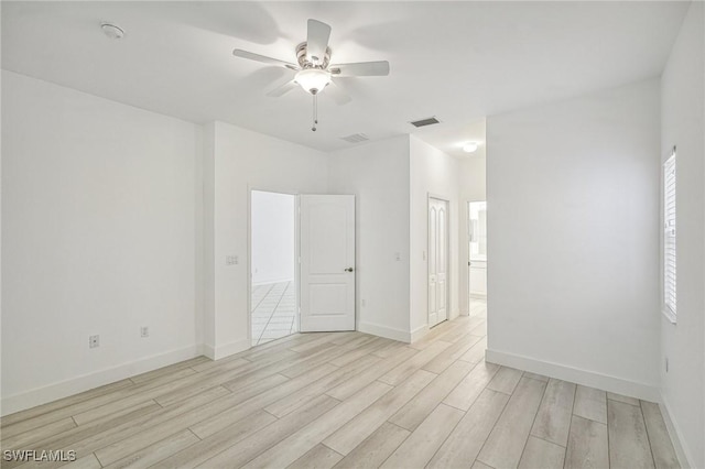 empty room featuring ceiling fan and light wood-type flooring