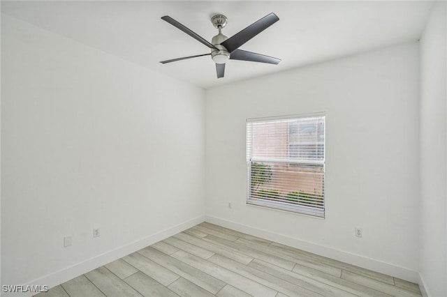 empty room with ceiling fan and light hardwood / wood-style floors