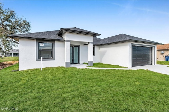 prairie-style home with a front lawn and a garage