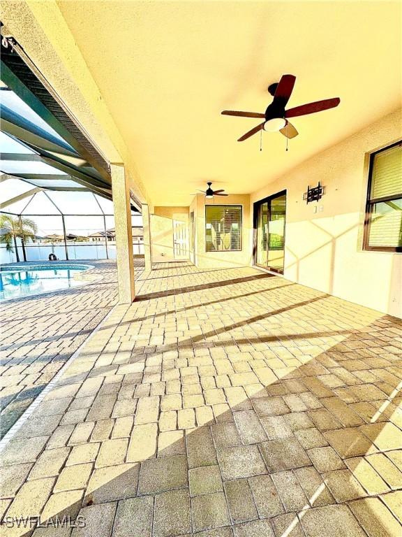 view of patio with a lanai and ceiling fan