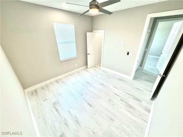 spare room featuring ceiling fan and light hardwood / wood-style flooring