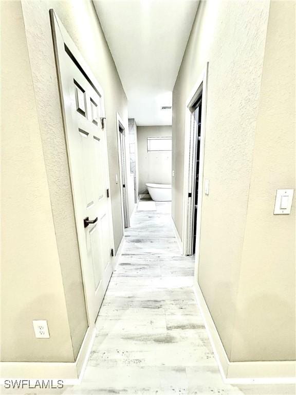 corridor featuring light wood-type flooring