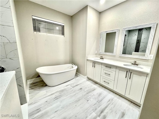 bathroom with vanity, a tub to relax in, and hardwood / wood-style floors