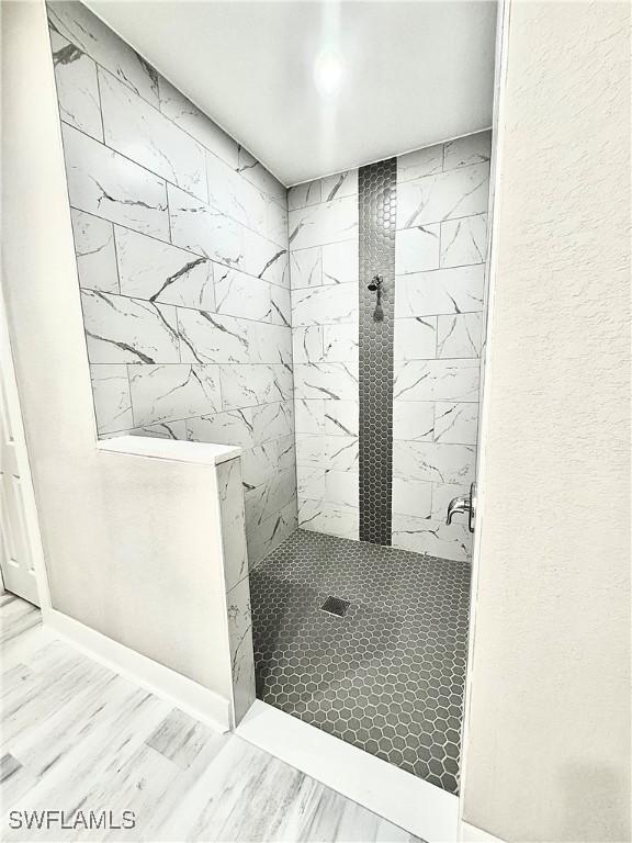 bathroom with tiled shower