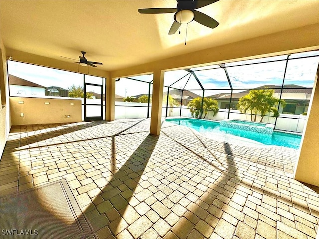 view of swimming pool with ceiling fan, a lanai, and a patio