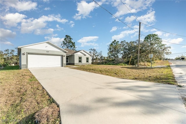 ranch-style house with driveway, an attached garage, and a front lawn