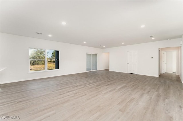 empty room with light hardwood / wood-style floors