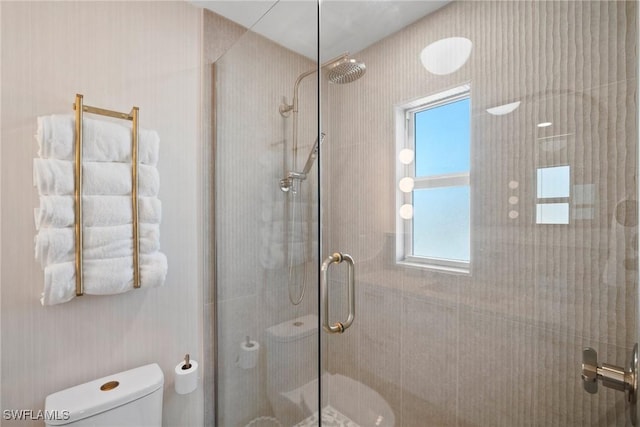 bathroom featuring an enclosed shower and toilet