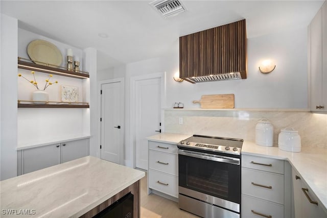 kitchen featuring electric range and tasteful backsplash