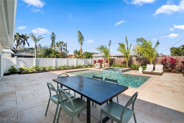 view of pool featuring a patio area and an in ground hot tub